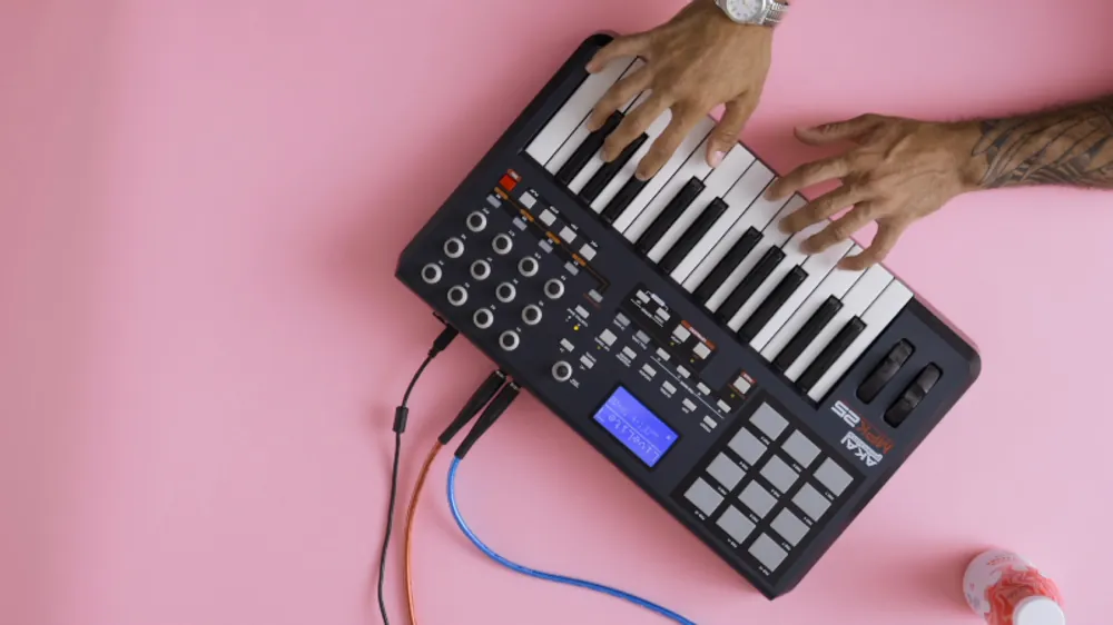 Hands on a beat pad on pink